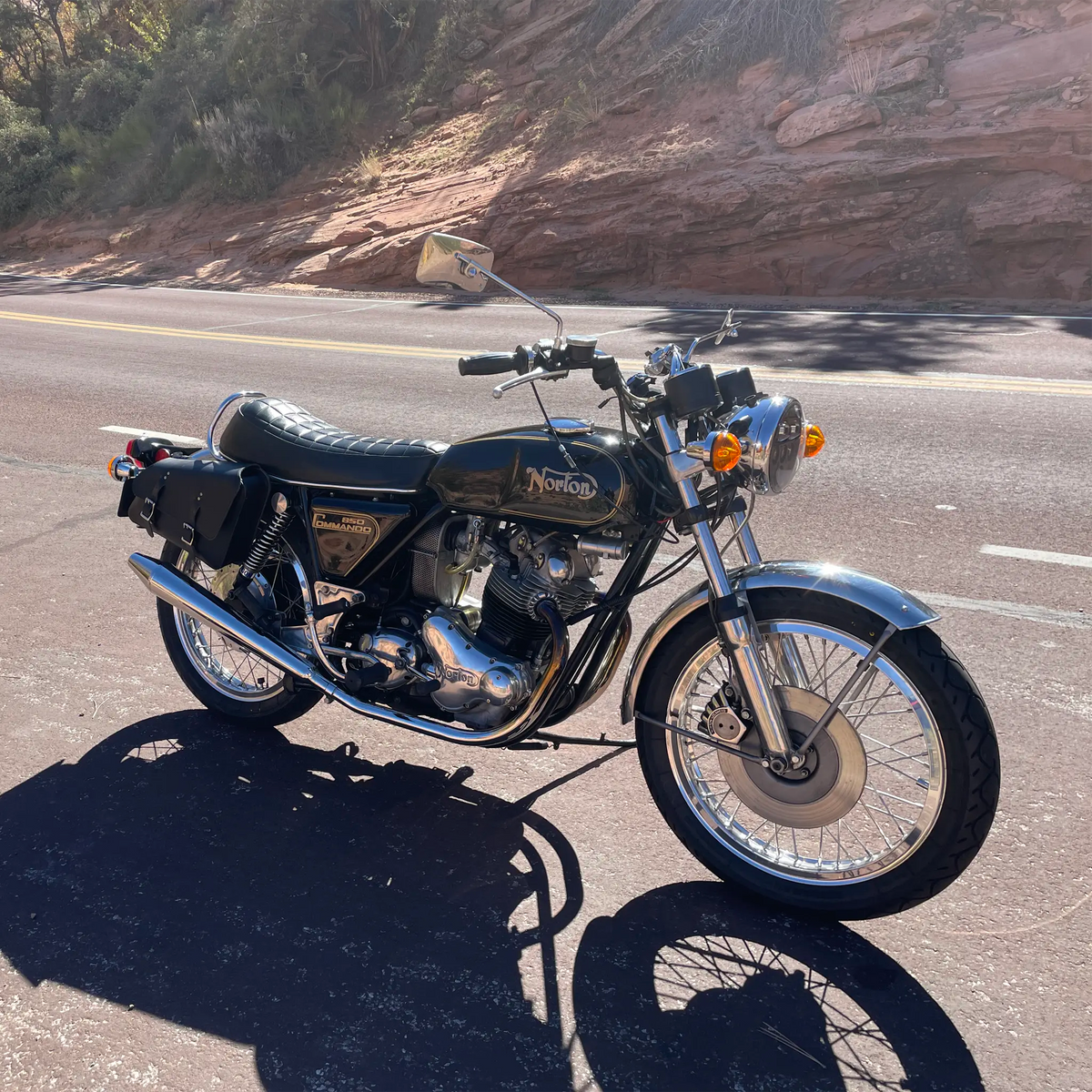 Vintage motorcycle on a road with a scenic background