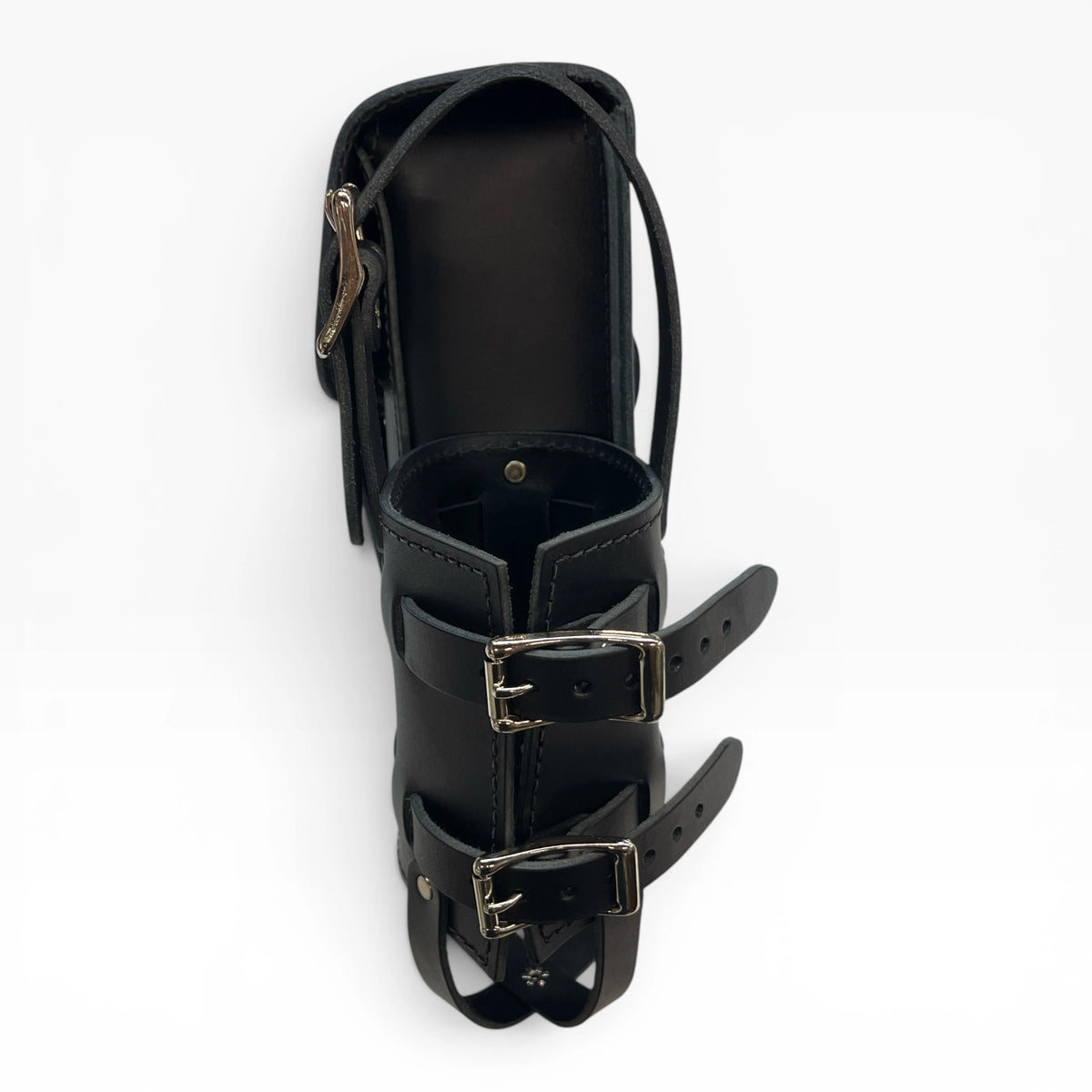 A black leather ankle boot with double buckle straps and a zippered side pocket, shown from a top-down angle on a white background.