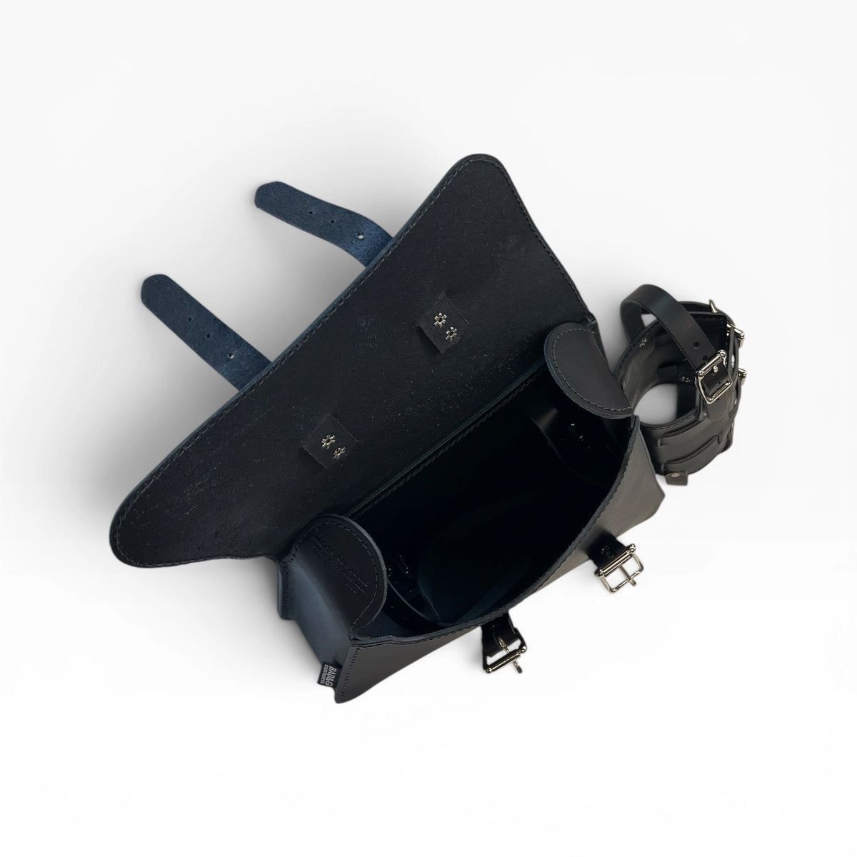 A black leather saddlebag shown from an overhead angle, featuring a dark blue leather strap and silver-tone metal buckles and hardware, set against a plain white background.
