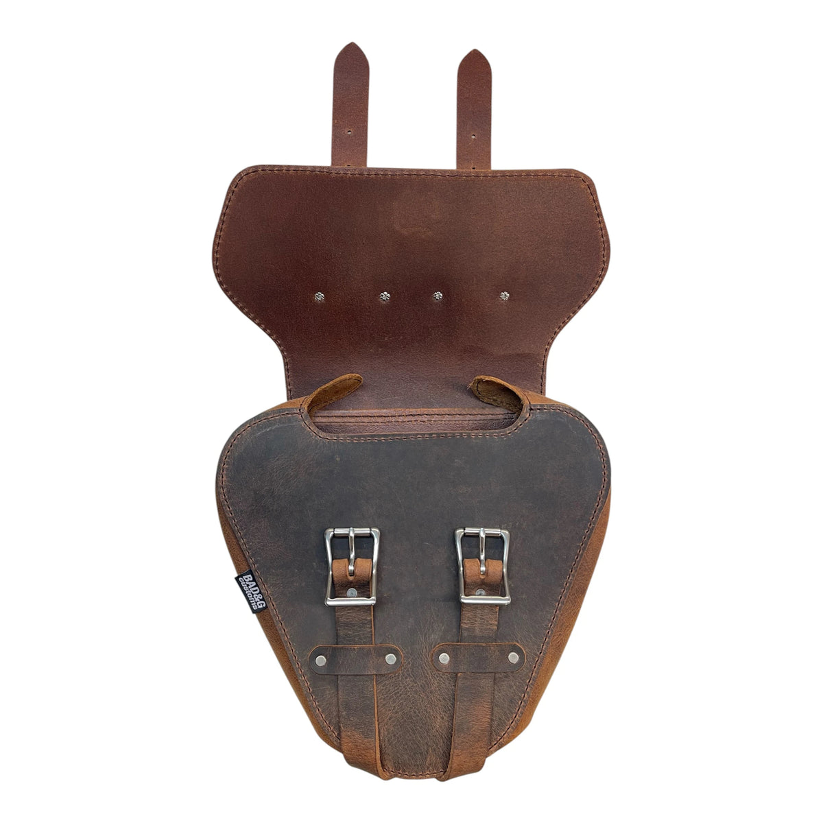 Brown leather saddlebag with metal buckles on a white background